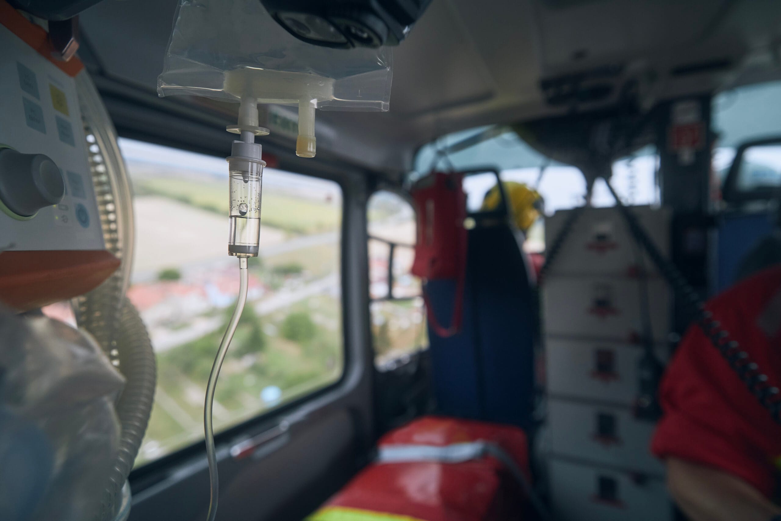 Selective focus on infusion on board helicoter of emergency medical service. Themes rescue, urgency and health care.