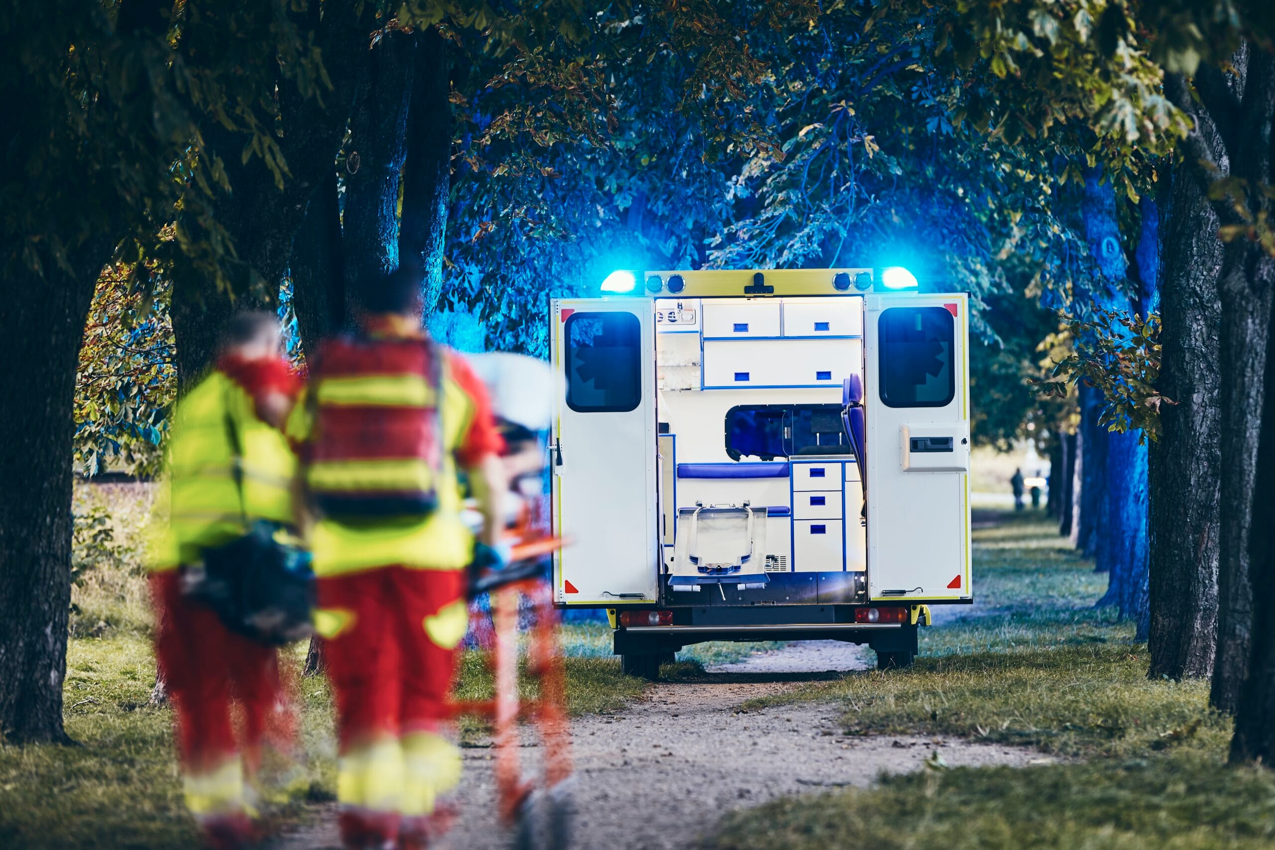 Paramedic and doctor pushing stretcher with patient to emergency ambulance. Themes teamwork, rescue and hope.